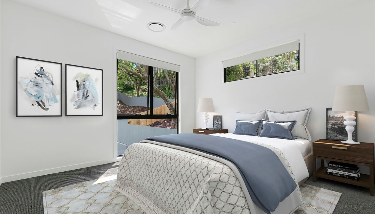 A bedroom with large blinds in the windows - how to clean your blinds blog featured image