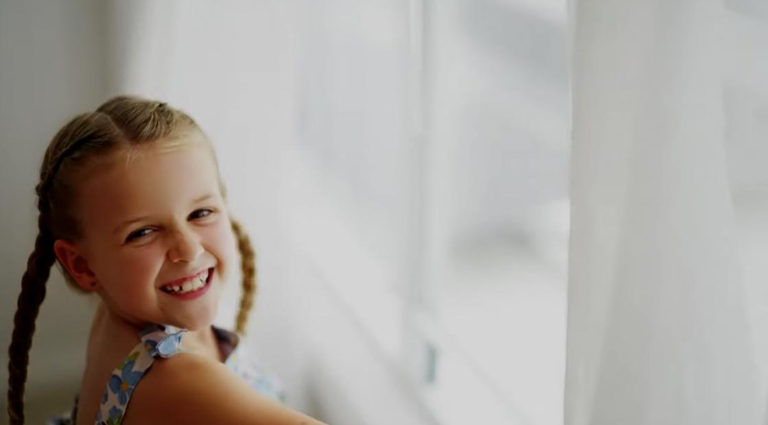 Young girl smiling | Featured image for Home.